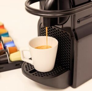 making espresso using a black coffee pod machine