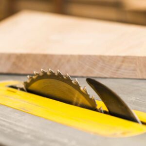 a sharp saw in wooden table