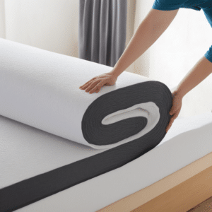 A woman rolling the mattress topper