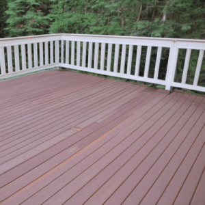 a nice brown deck with white fence