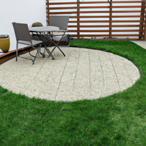 a small garden patio with chairs and a table