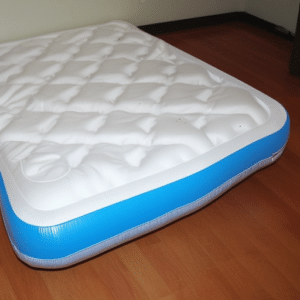a white and blue bed on the floor