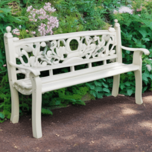 a white garden bench with roses behind it