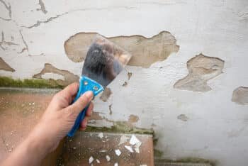 a woman's hand scraping the walls