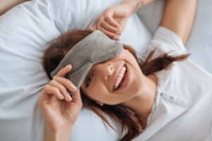 happy young woman in bed