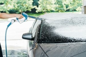 man washing car