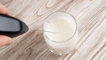using handheld tool to create milk foam