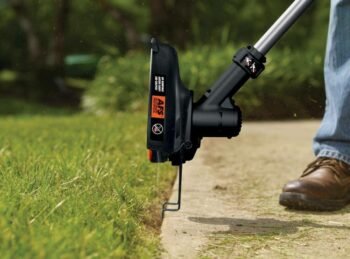 whacking grass near a pavement