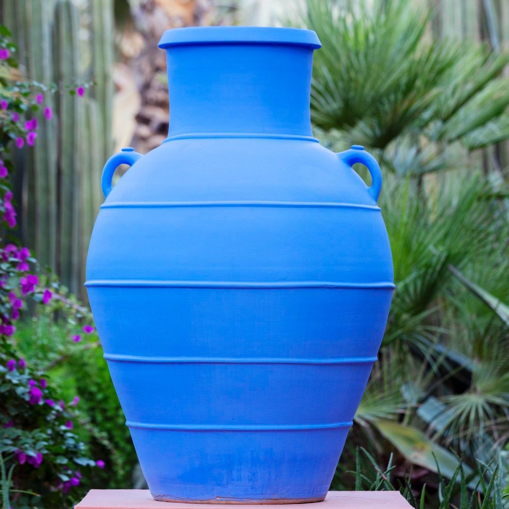 a blue vase in the garden