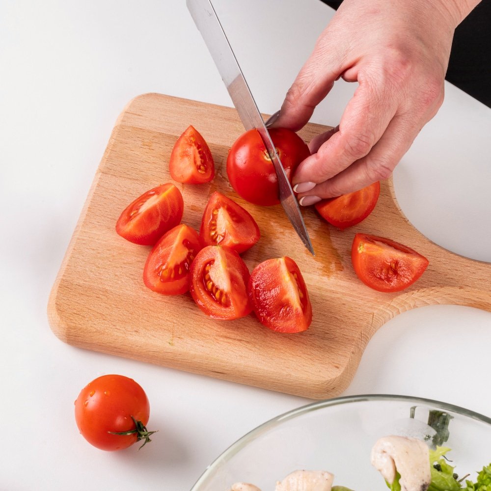 a chef chopping fresh tomatoes