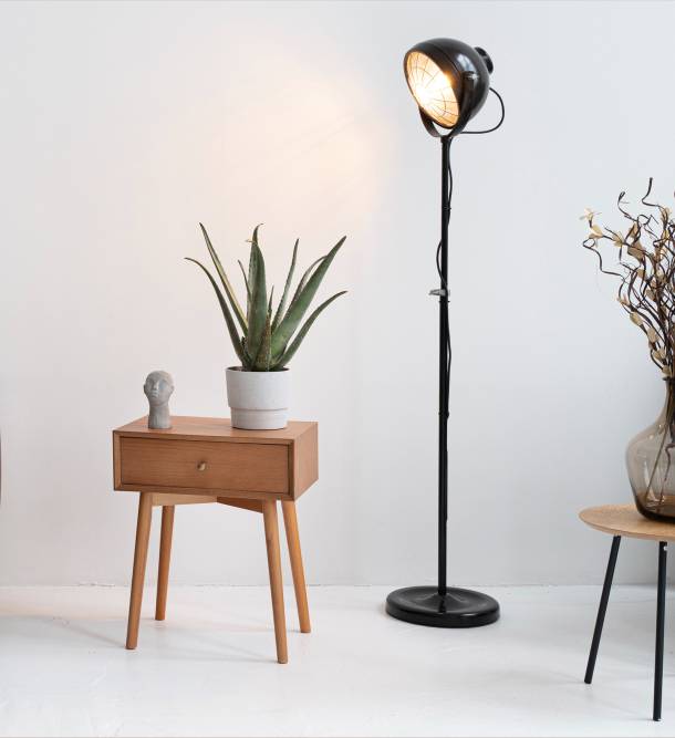 a floor lamp next to a small table