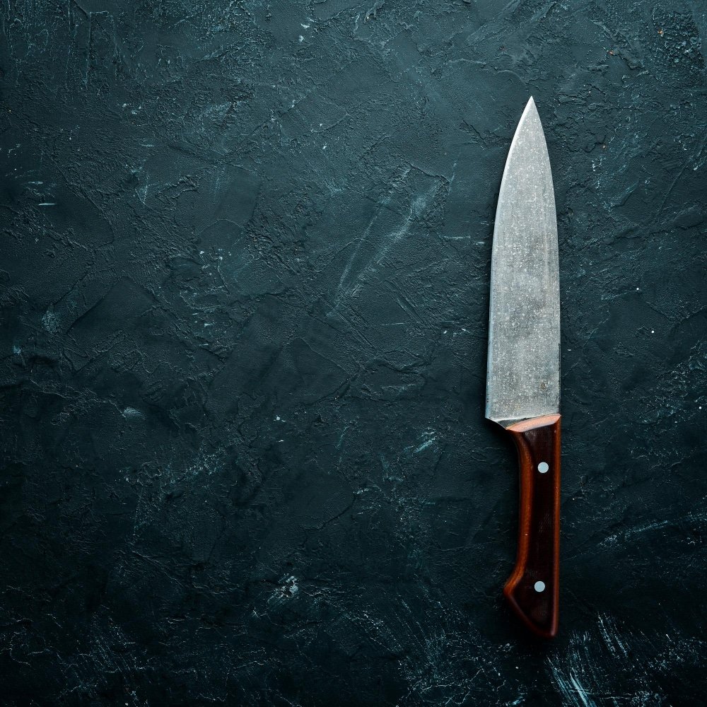 a kitchen knife on a black stone table