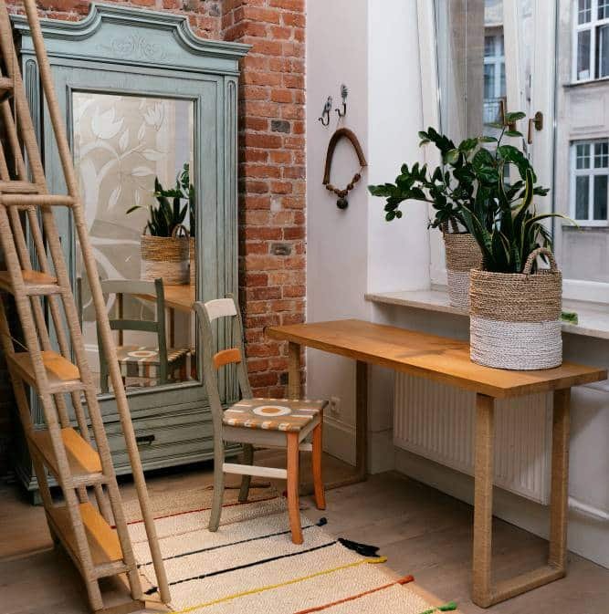 a loft ladder, a wooden chair and wooden table