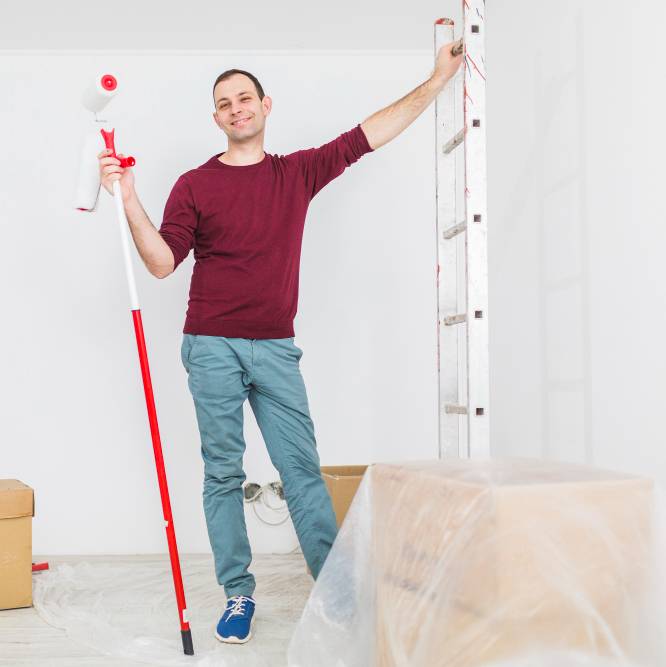 a man with ladder and paint roller