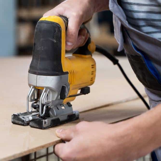 a man working on cutting mdf board