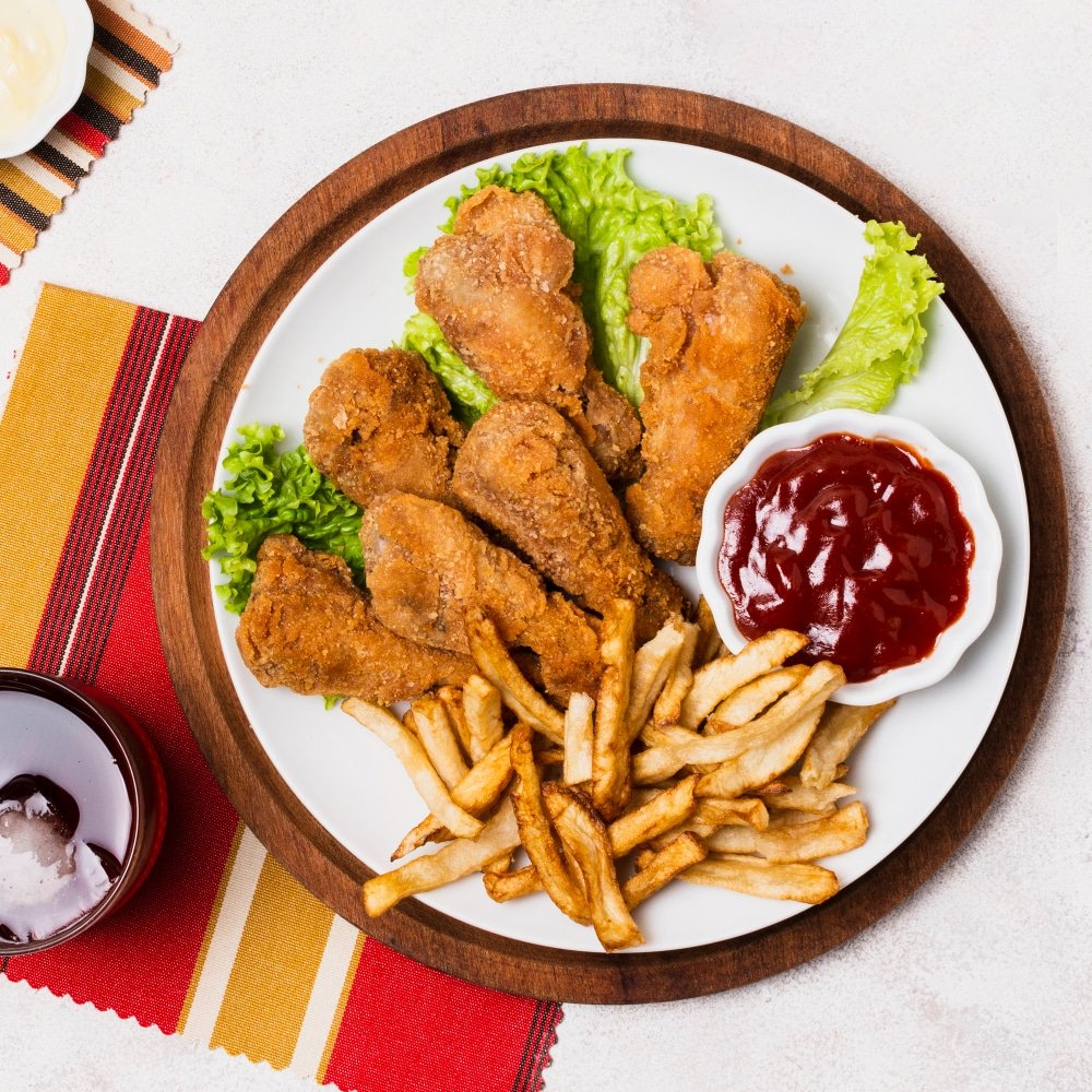 a plate of of fried chicken and fries
