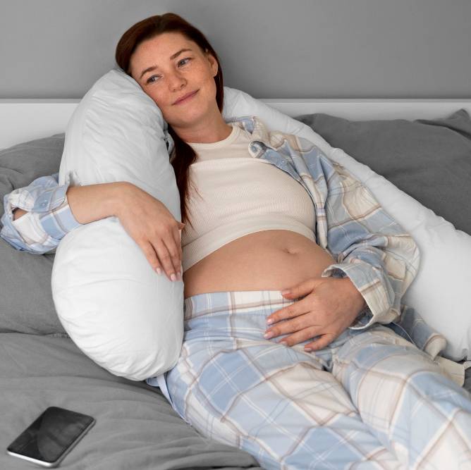 a pregnant woman relaxing in bed