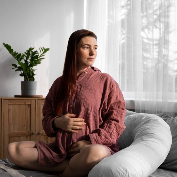a pregnant woman sitting in bed