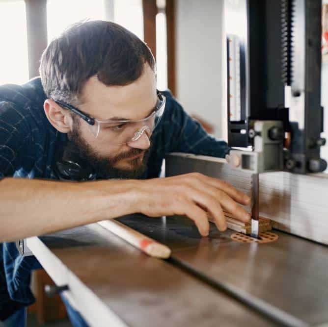 a professional carpenter working with a router table