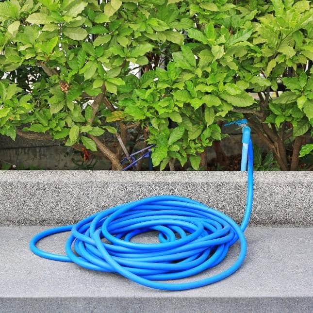 blue garden hose on concrete