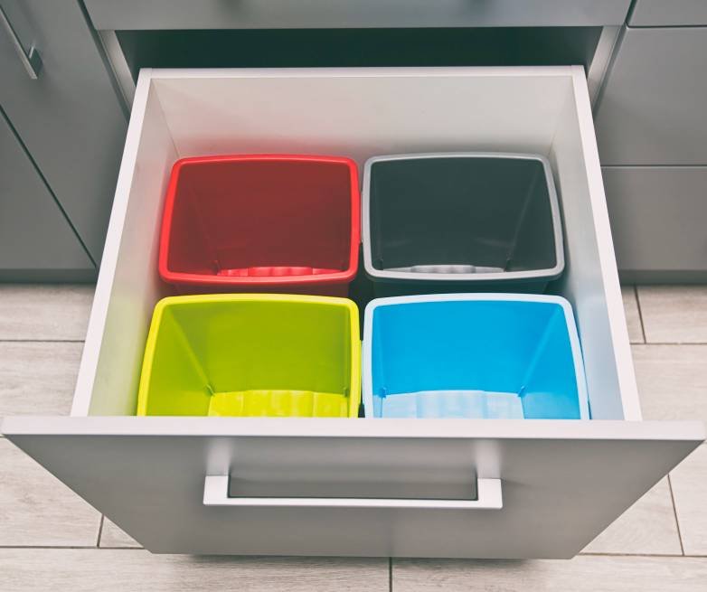 empty plastic trash bins in a shelf