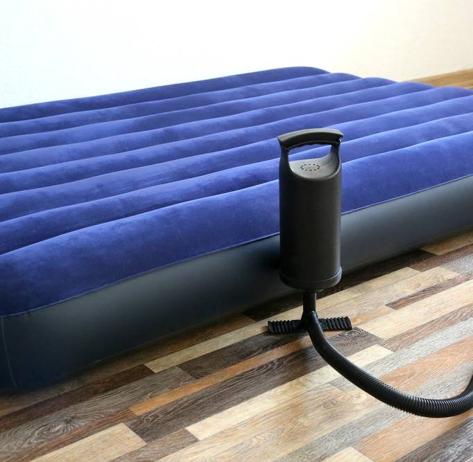 inflating a blue air bed in the room